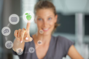 woman touching a graphic of an apple on a screen