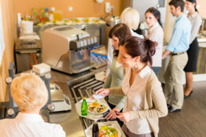 group of women getting food in cafeteria